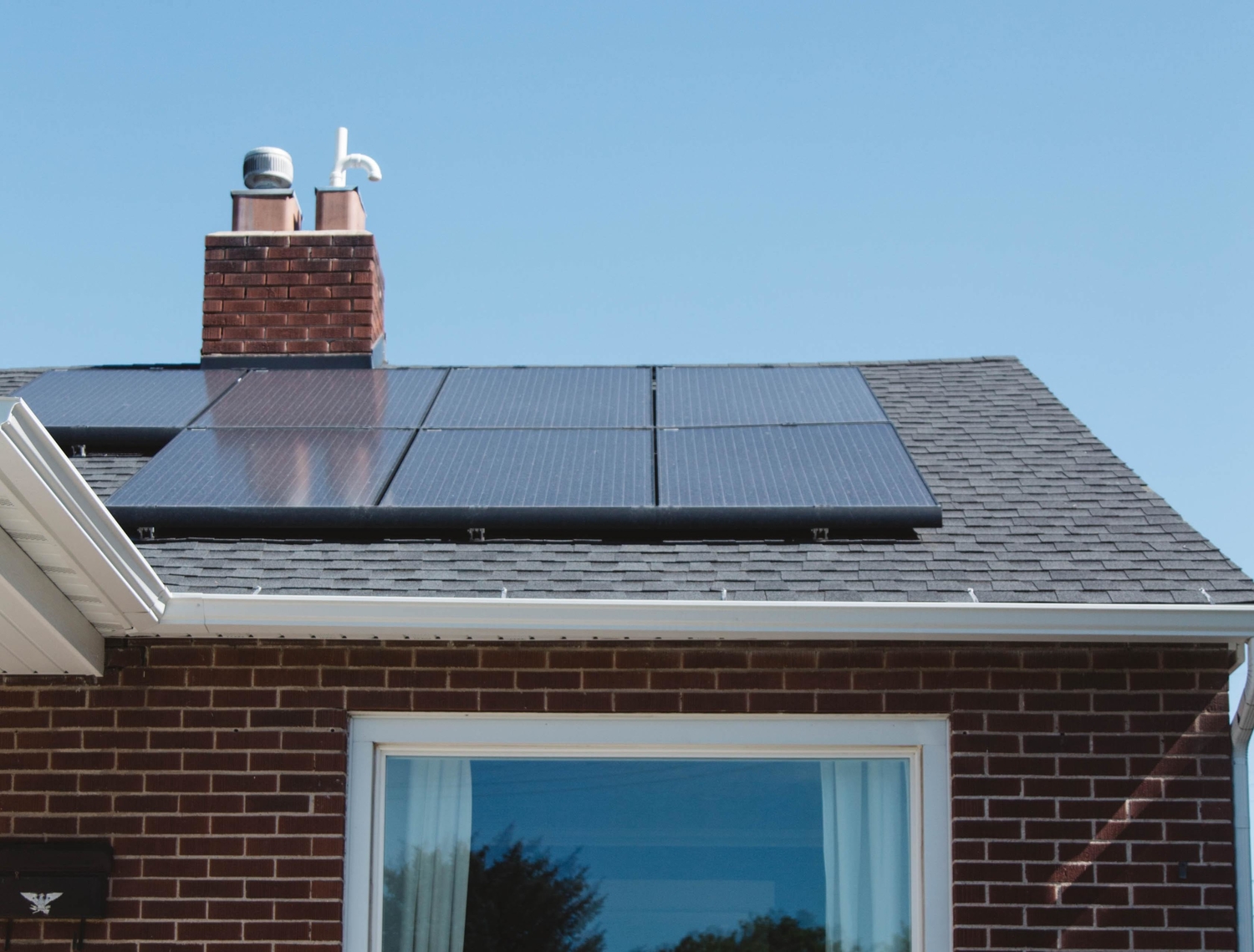 a residential home with solar panels on the roof