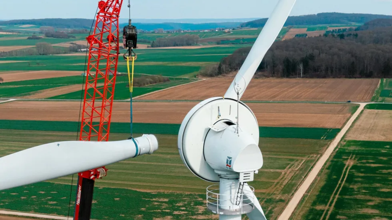 Crane installing wind turbine wings