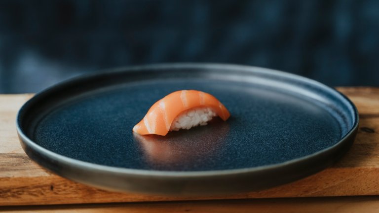 Lab grown salmon on sushi rice on a plate